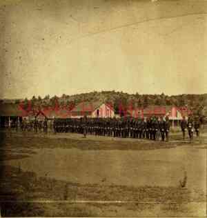 Sepia photograph from 19th century of soldiers lined up for inspection outdoors