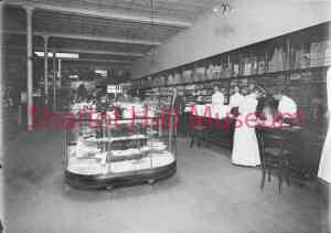 Antique black and white photograph of Bashford-Burmister store interior with women at counter looking at goods